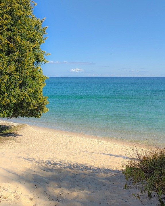 Photo of a sand beach on Rock Island with Lake Michigan in the background