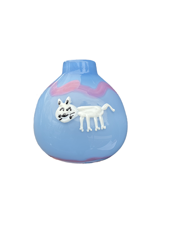 A blue glass object created by George Kennard featuring a white cat and purple stripes. 