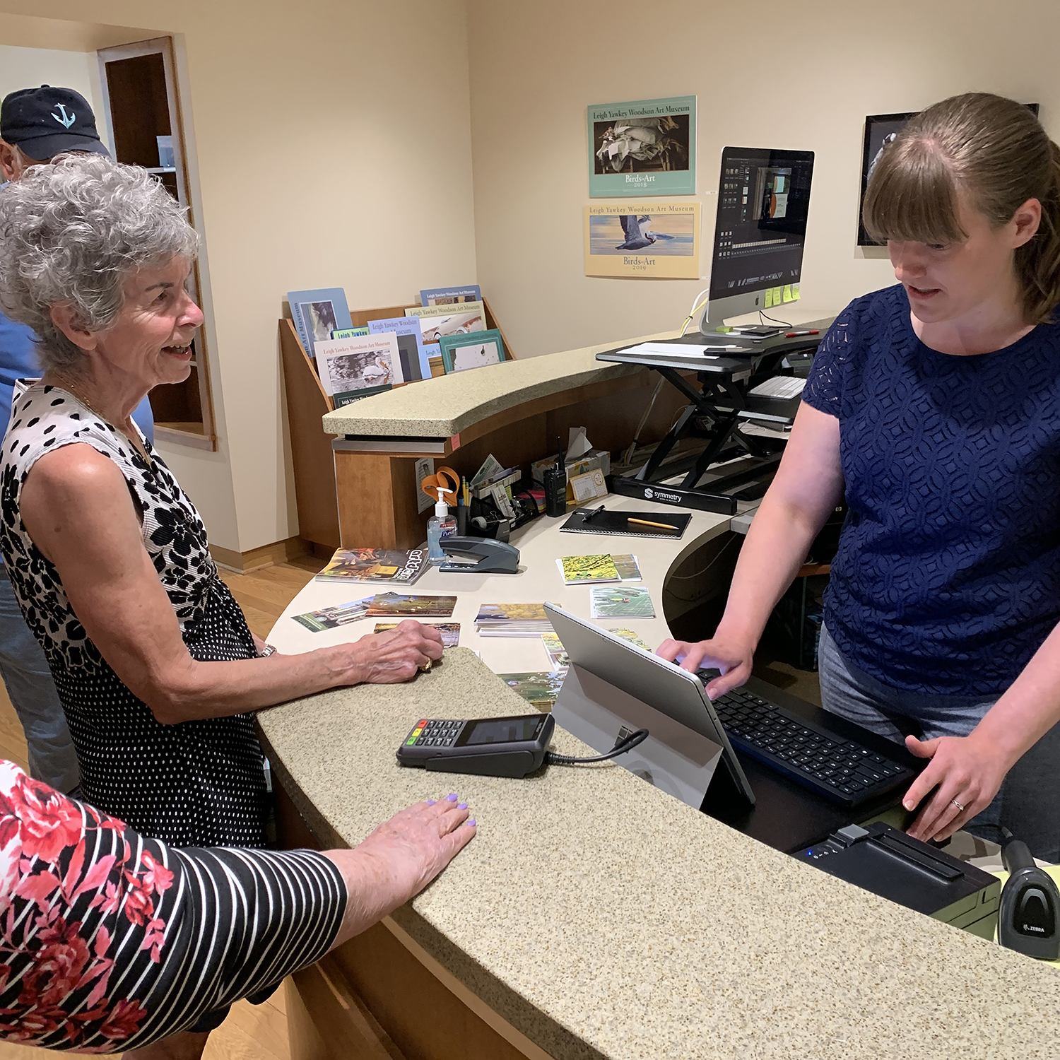A Woodson Art Museum visitor purchases notecards and postcards at the new register