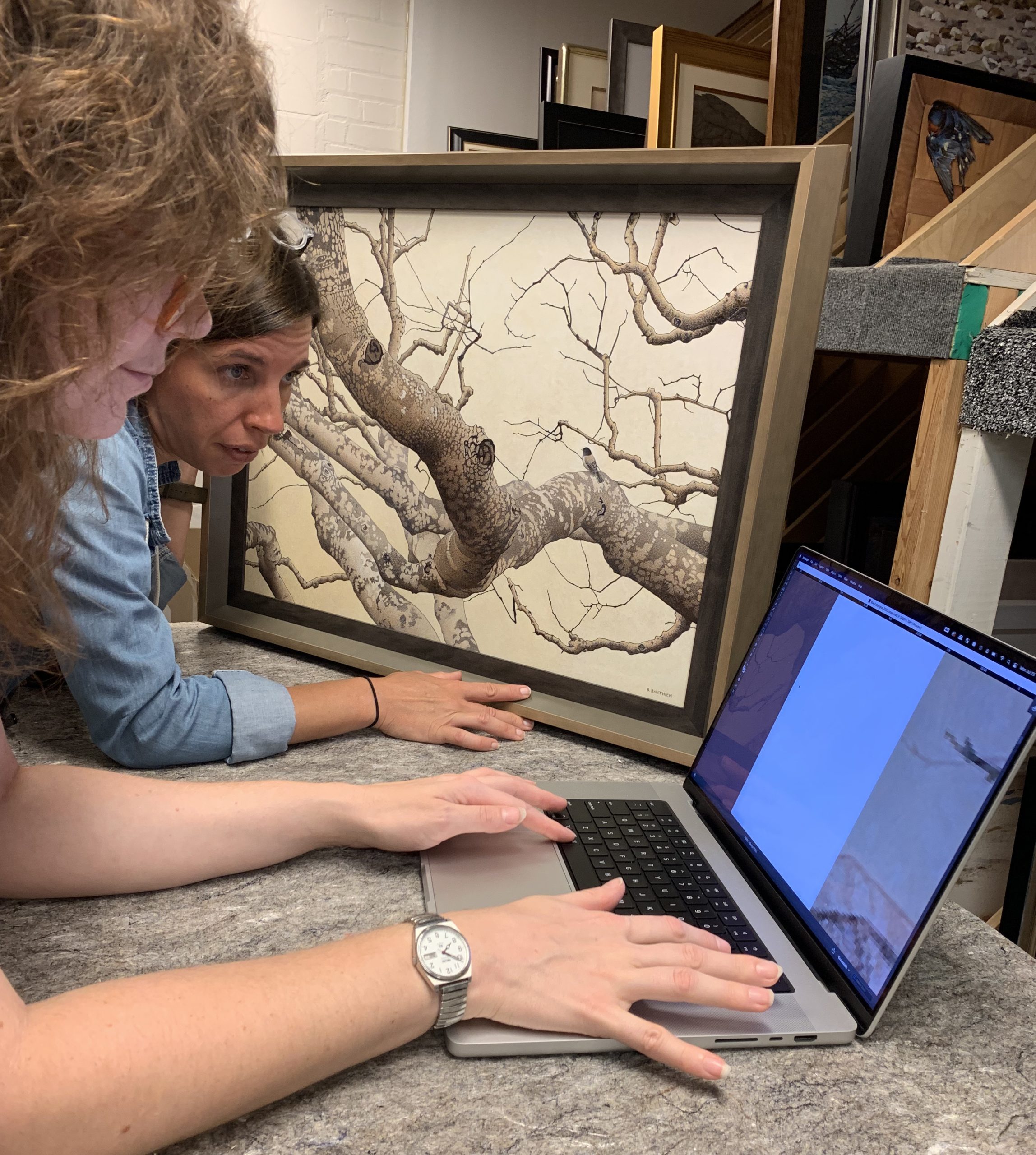 Shannon Pueschner, curator of exhibitions and Amalia Wojciechowski, curator of collections making edits to the cropping of images.