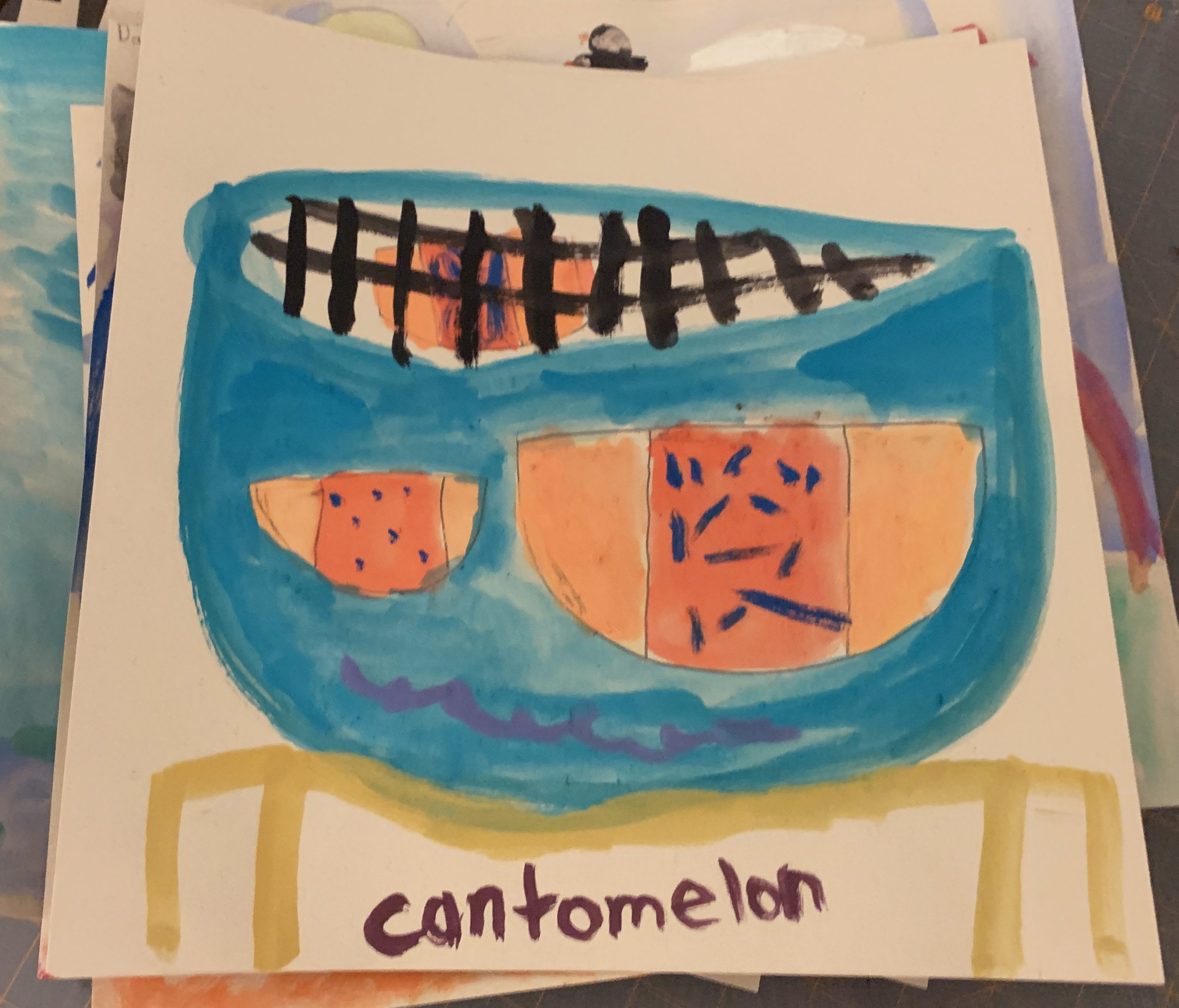 A child's drawing of a cantomelon shows two half-moon shapes inside of a blue watermelon.