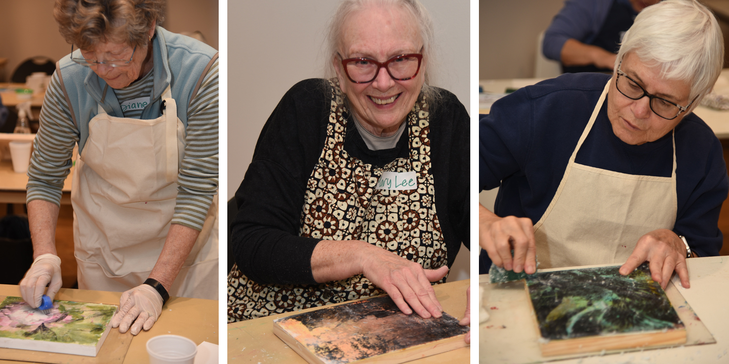 Workshop participants transferring images onto mixed-media panels with various different colors of underpainting
