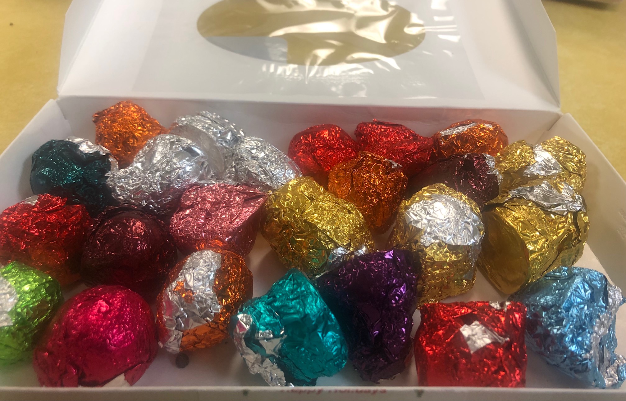 This image shows several homemade truffles wrapped in different colors