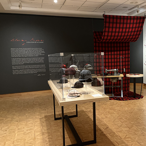 Stormy Kromer hats in the Woodson Art Museum exhibition gallery