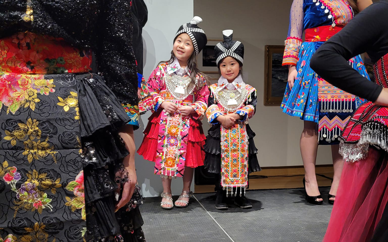 Two young girls model Hmong clothing during Regalia Runway