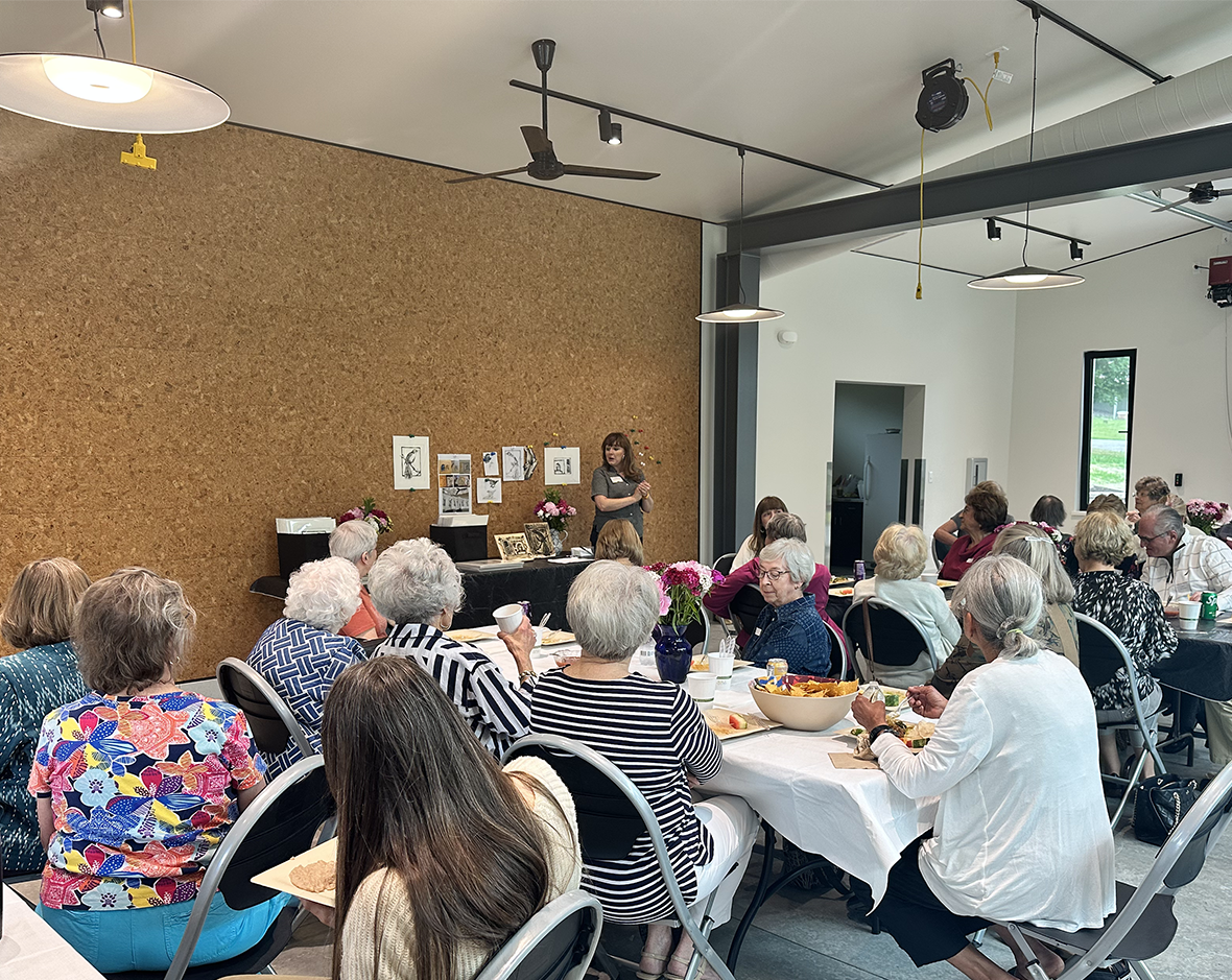 Volunteers and staff gather to celebrate volunteer service at the Glass Box Studio