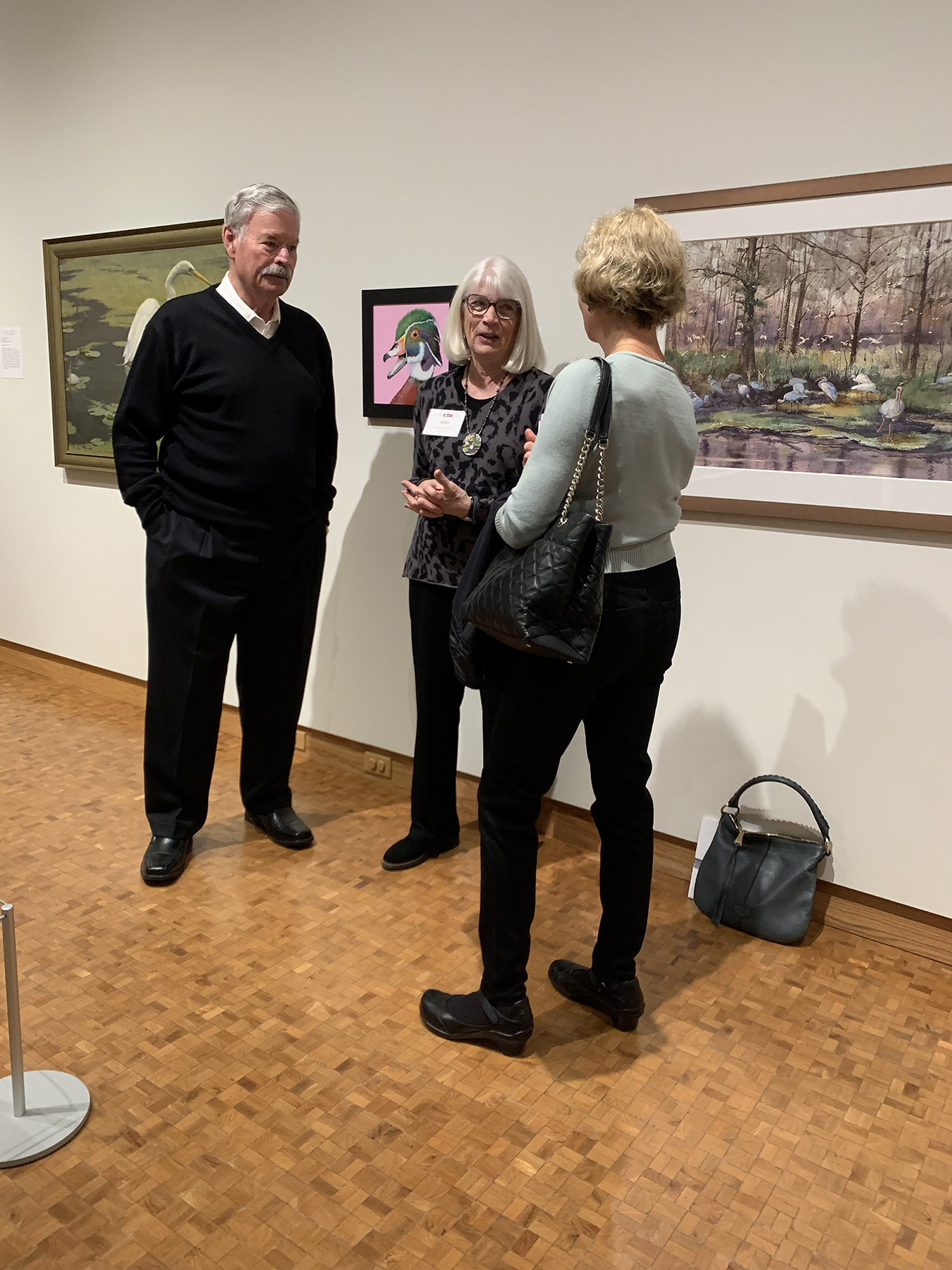 Kris Parins talks in front of her artwork during a Members Preview Gallery Chat