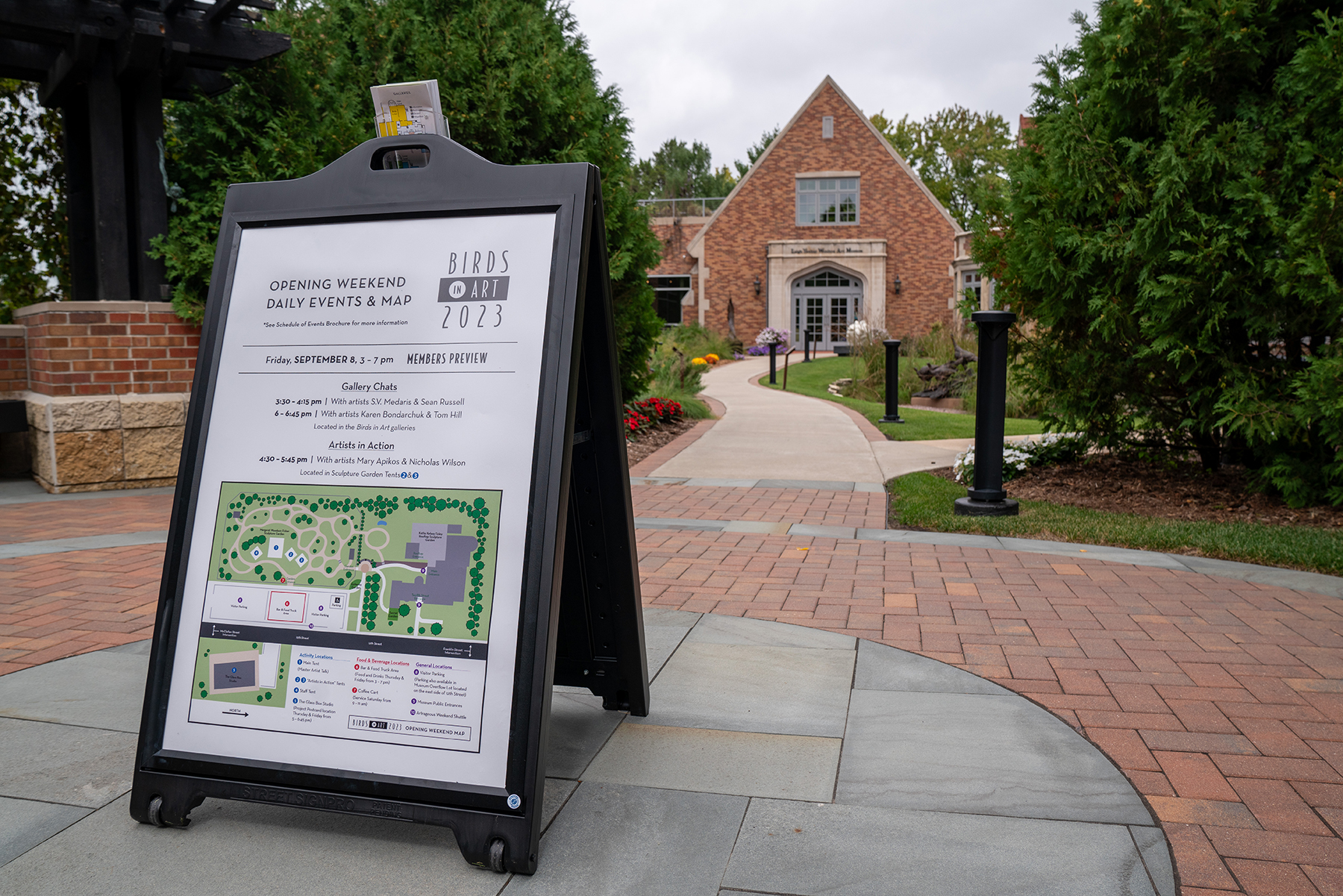 sign with the opening weekend in front of the museum enterance