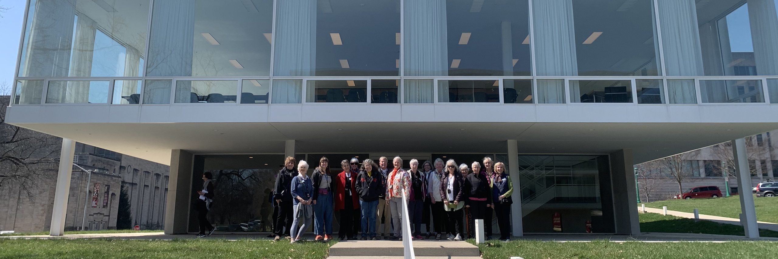 Travelers stand in front of building