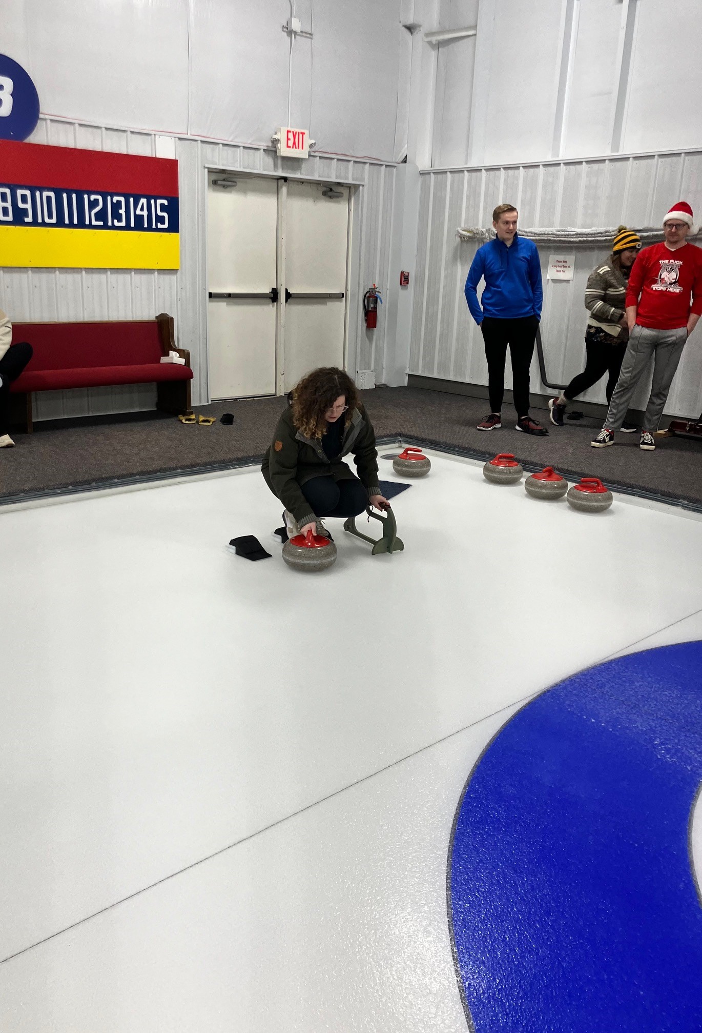 This image shows Curator of Education Emily Fritz preparing to throw a curling stone