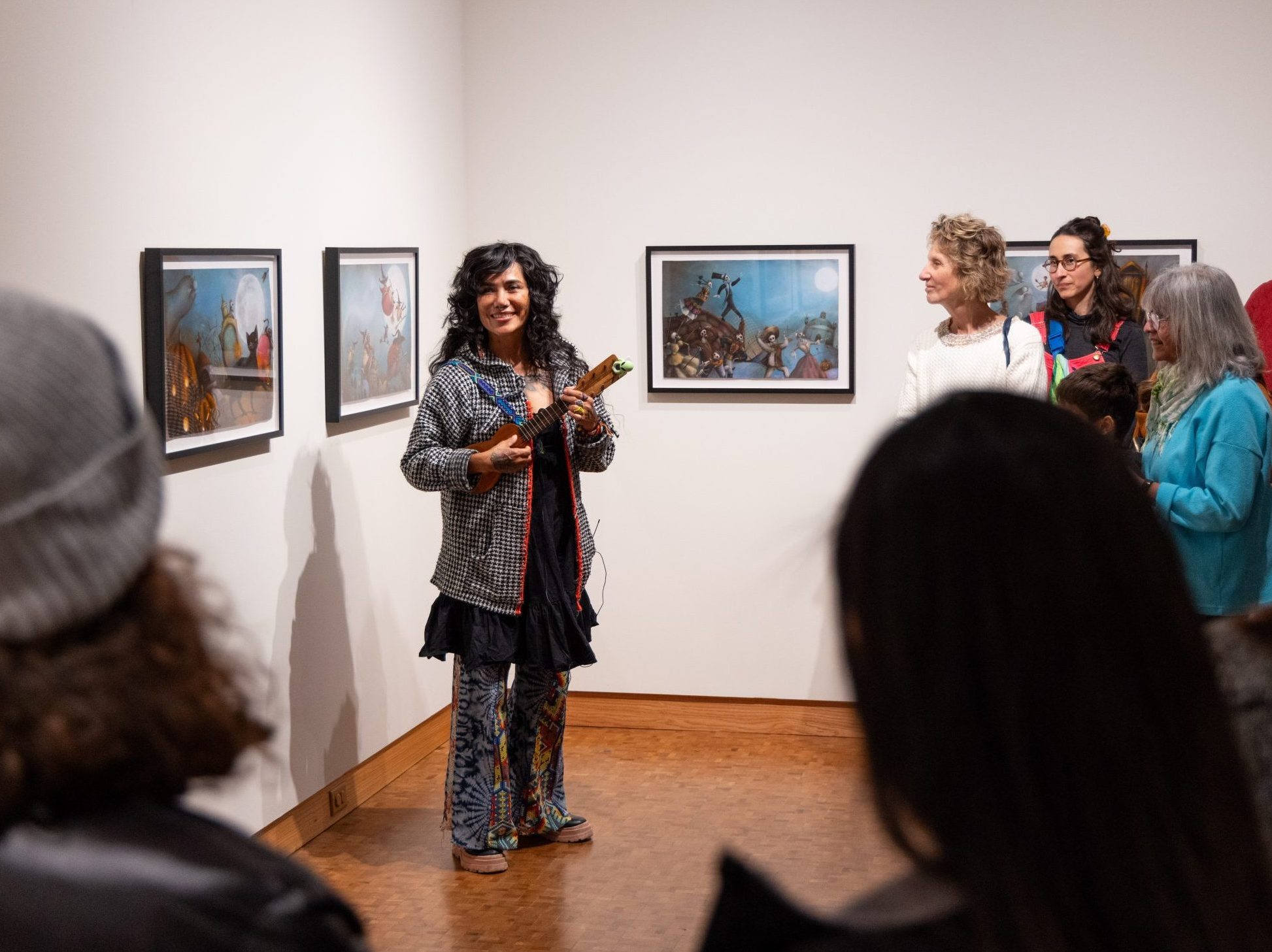 Artist in Residence Yuyi Morales, explaining her work during a recent gallery walk at the Woodson Art Museum
