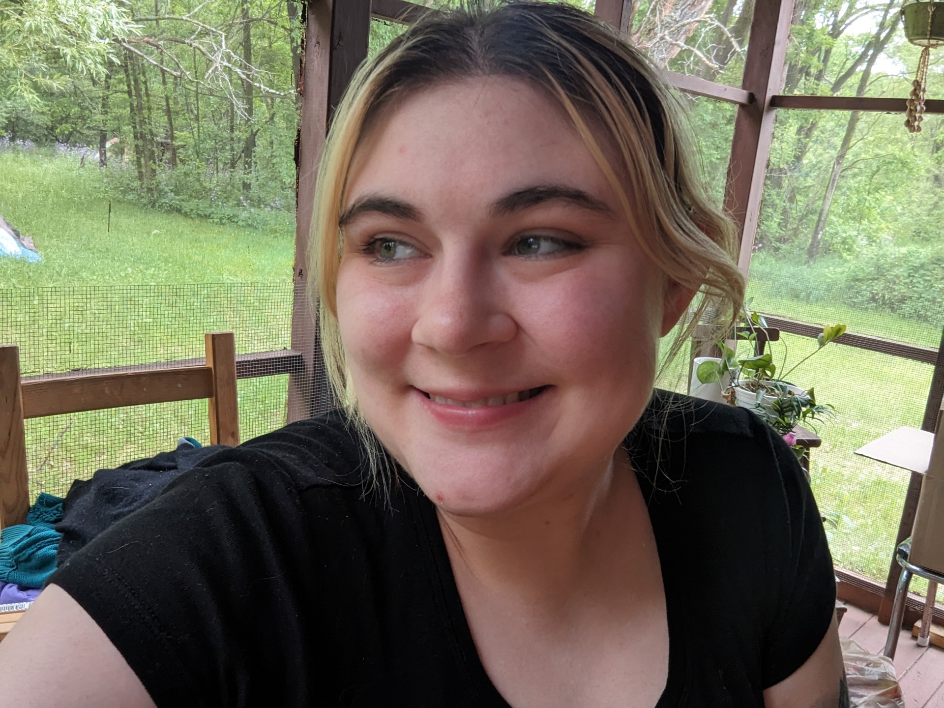 Person with blond hair smiles