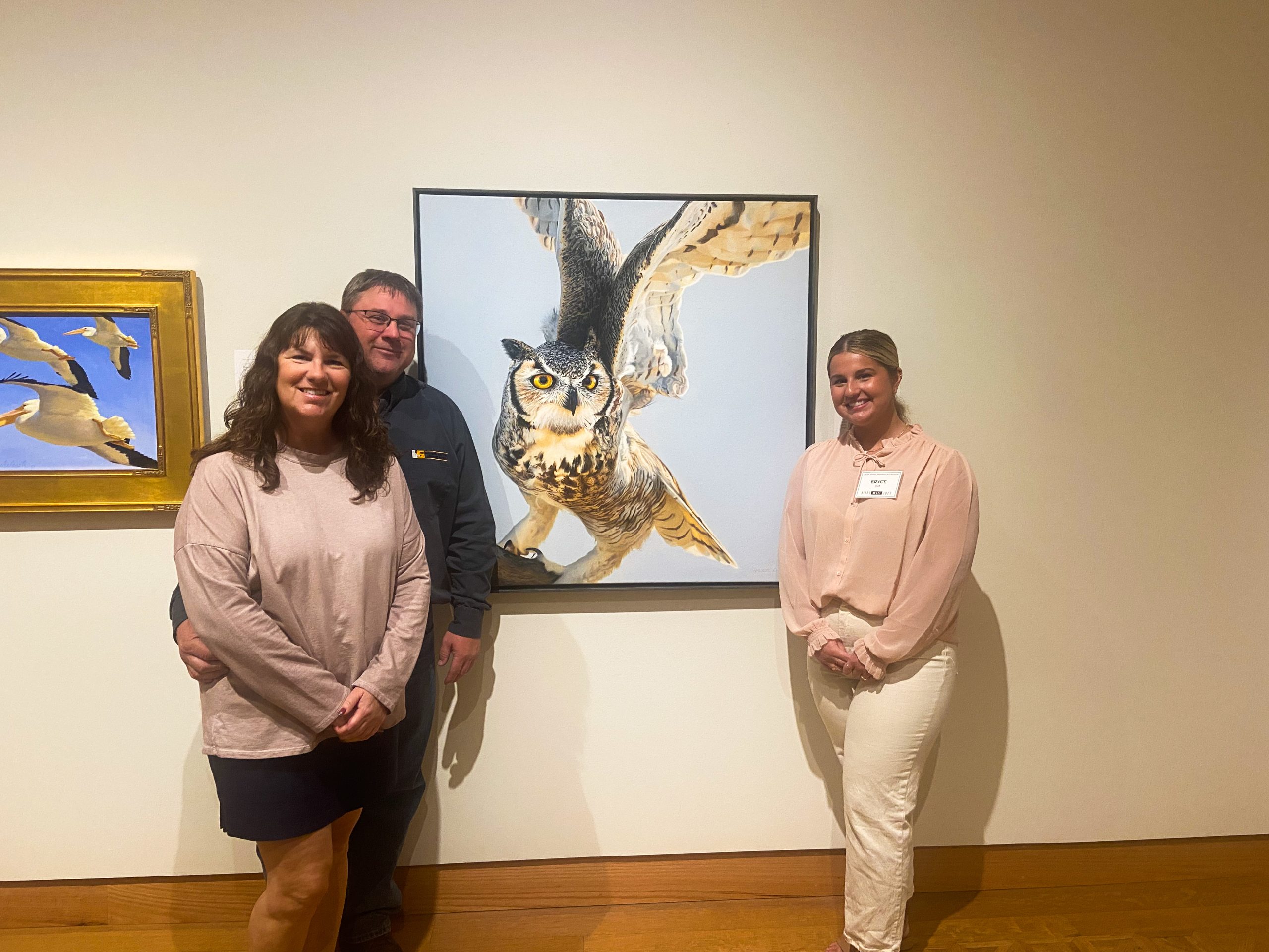 Museum staff member Bryce and her parents during "Birds in Art" opening in fall of 2023.