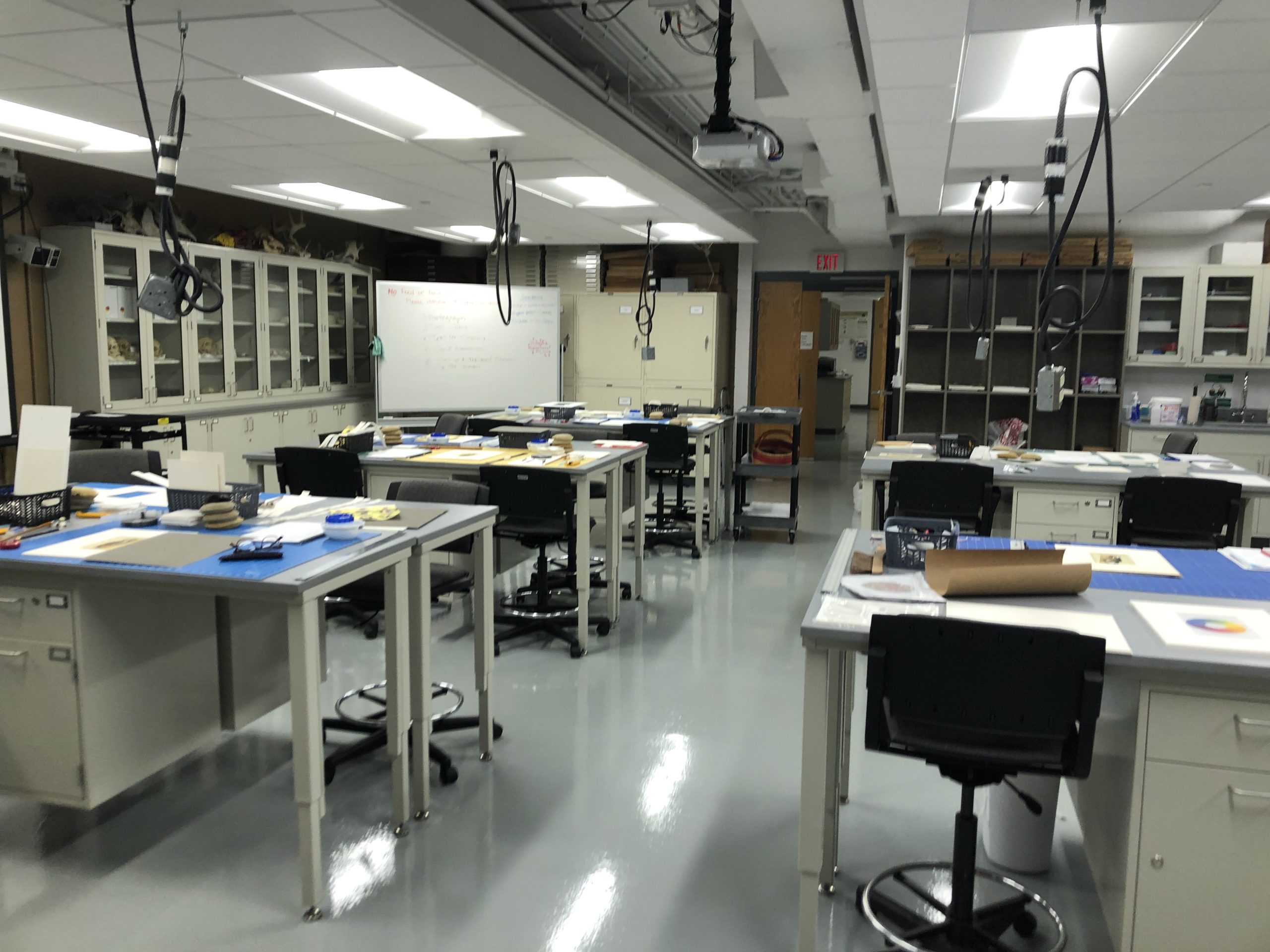 A lab with five tables and matting materials laid out.