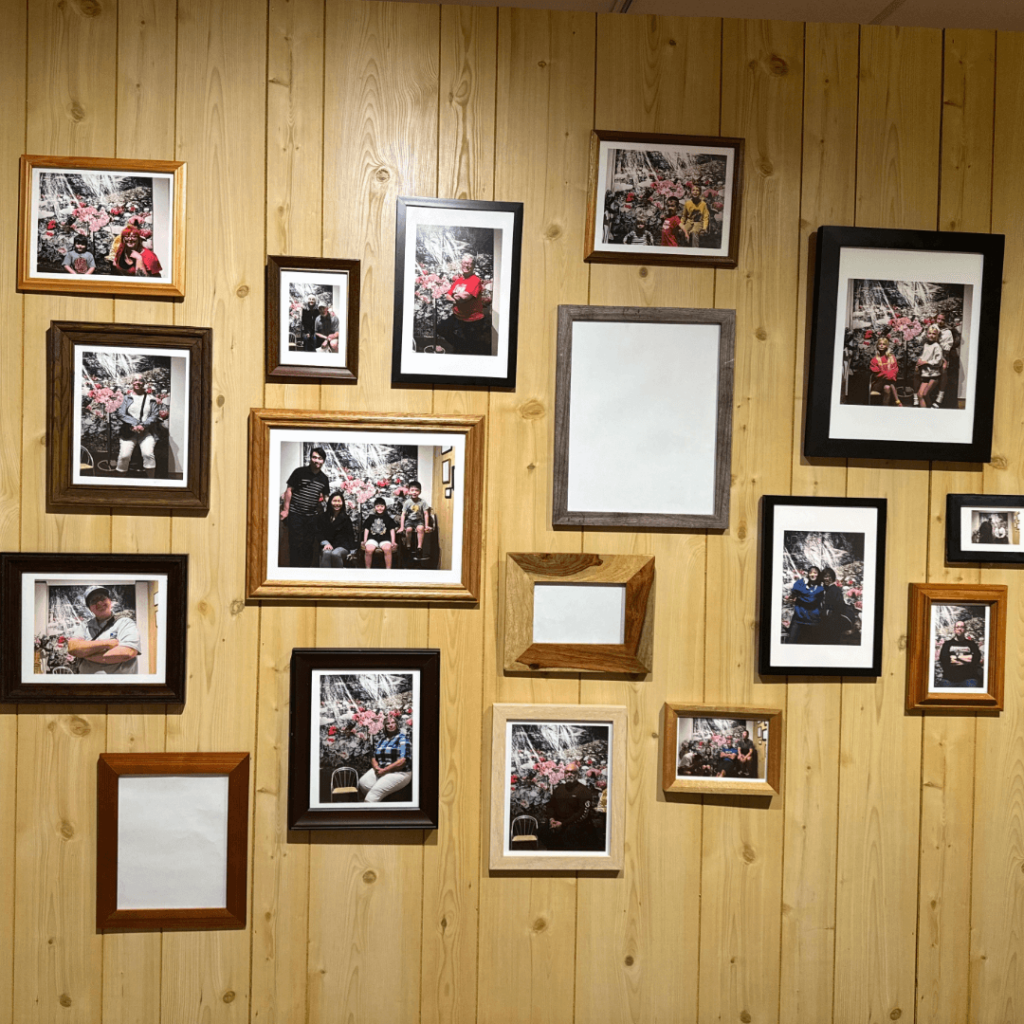 image of a wooden panel gallery wall filled with different size and style of picture frames.