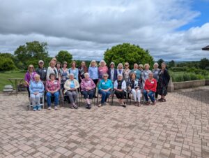a group of volunteers standing for a photo outside during their party at Willow Springs. 