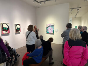 A group of people standing in a gallery at the Georgia O'Keeffe Museum.