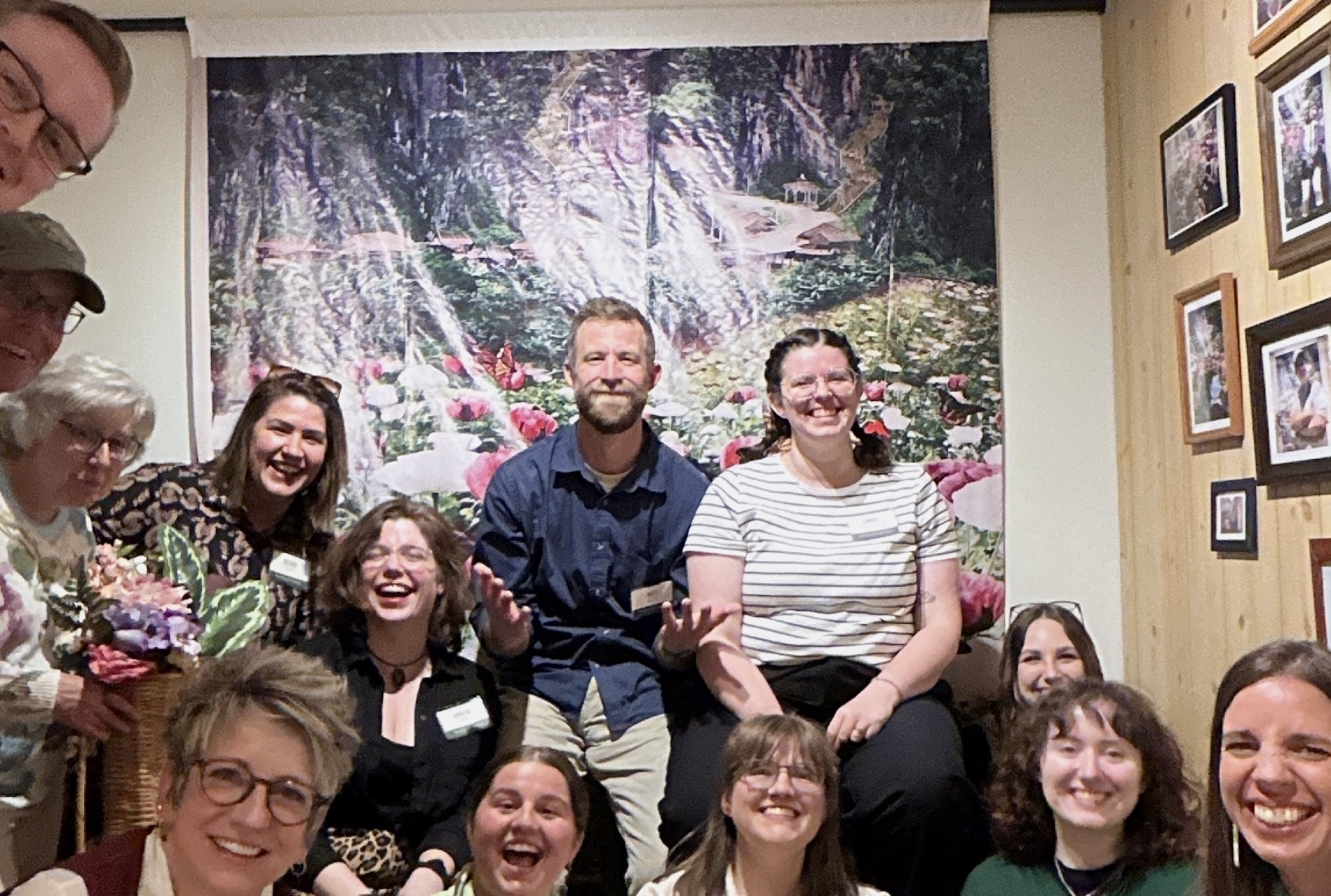 Museum staff posing in front of Pao's backdrop in the gallery